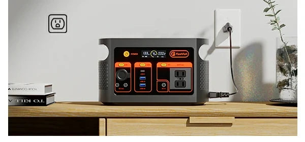 FlashFish power station on a table beside a wall outlet