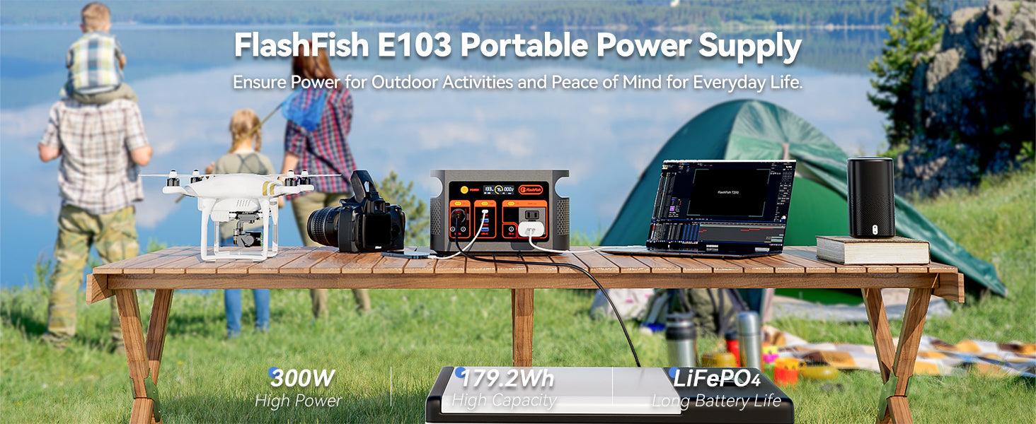 FlashFish portable power station with camping equipment at a lakeside campsite