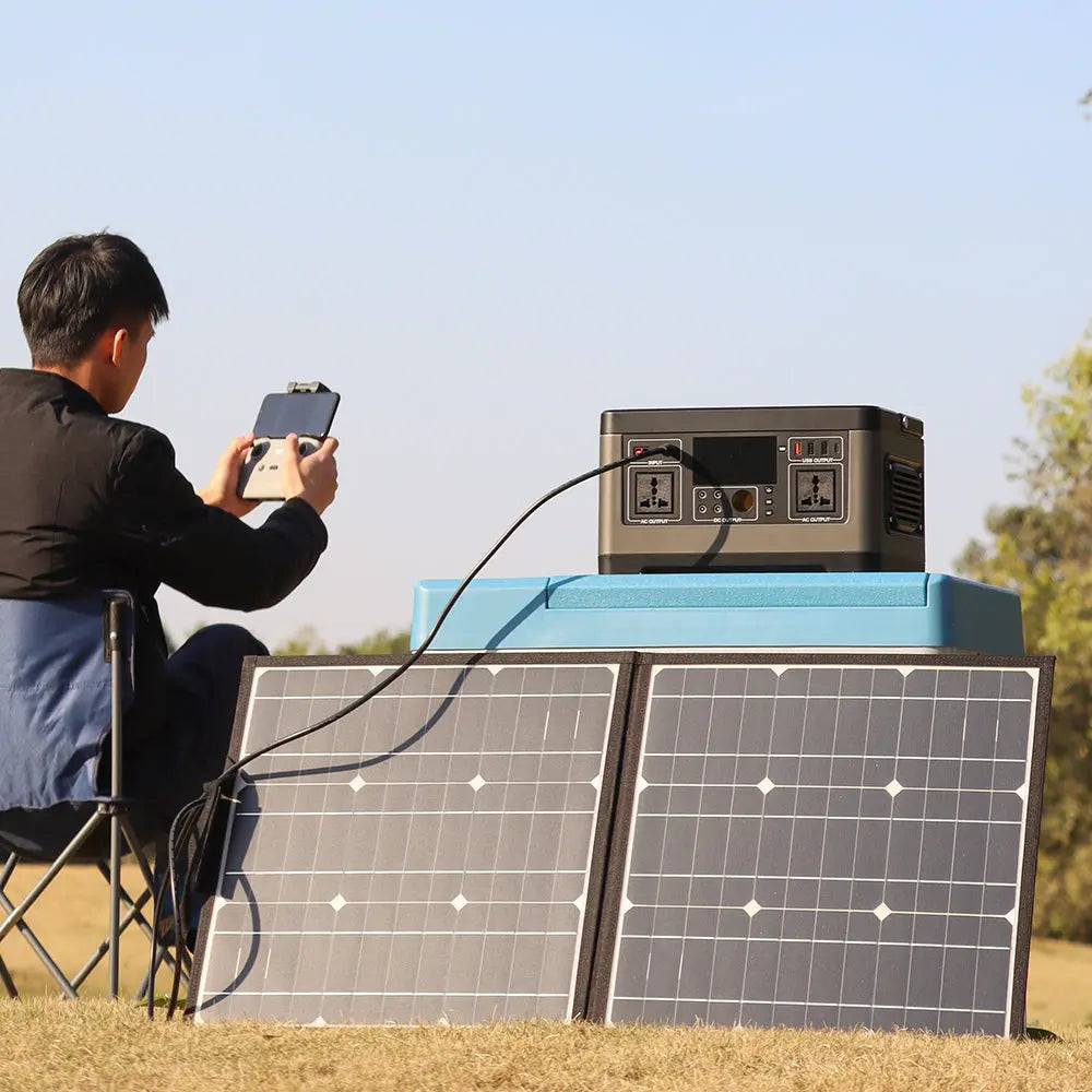 Portable power station and foldable solar panel at a campsite