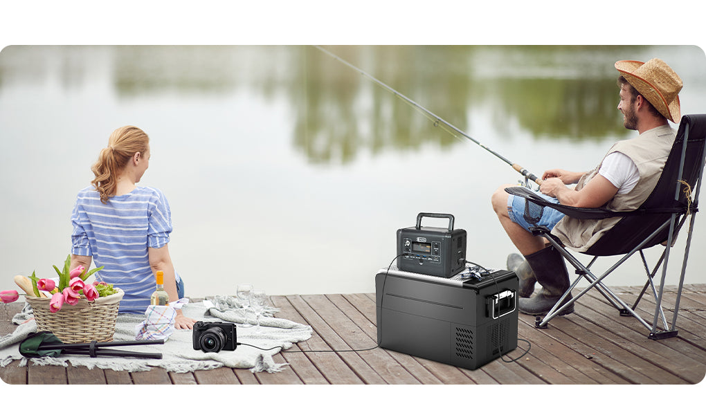 A FlashFish T200 and camera equipment beside a lakeside picnic setup.
