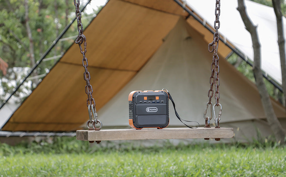 FlashFish A101 mini portable power station outdoors near a tent