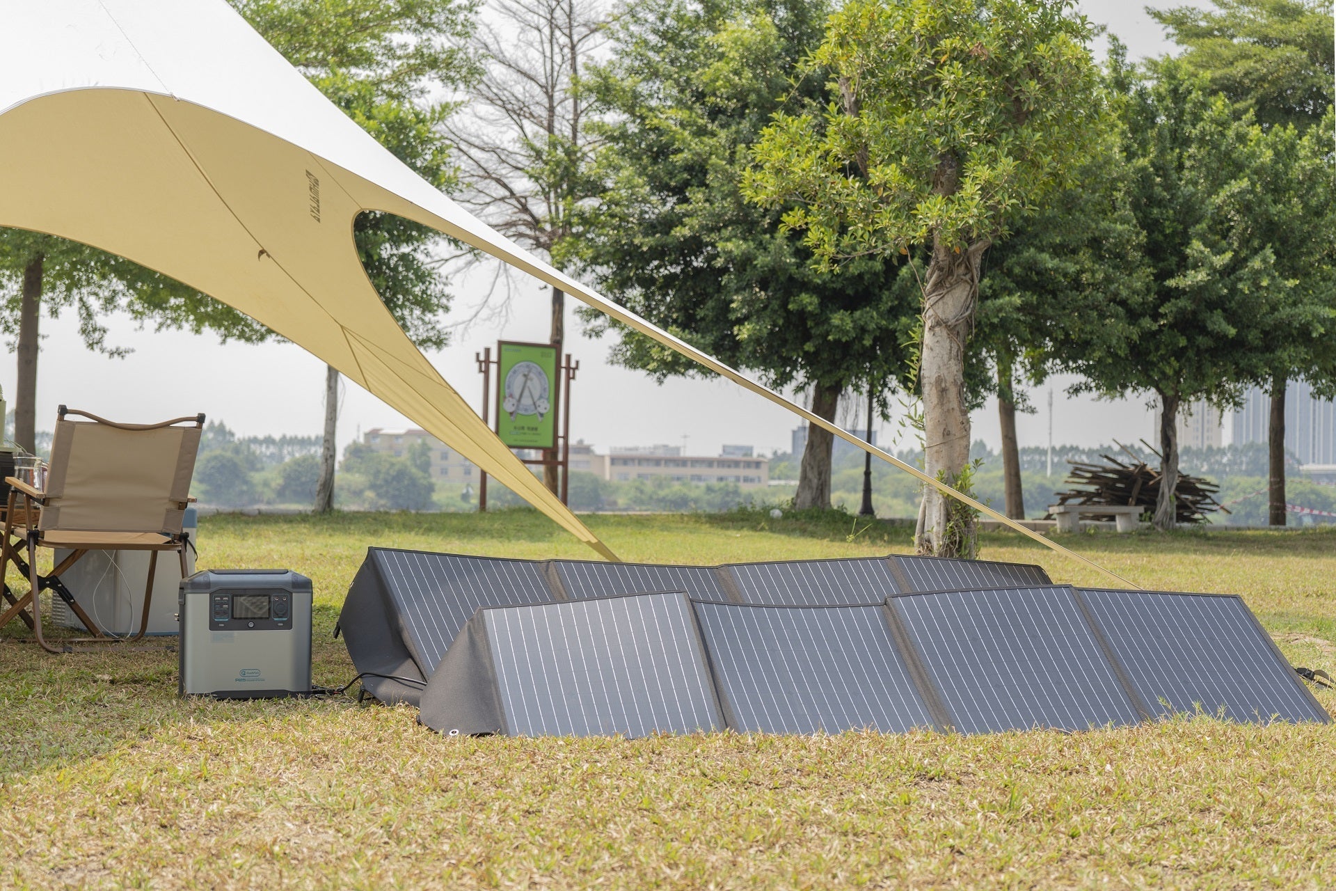 Foldable solar panels charging a portable power station at a spring campsite