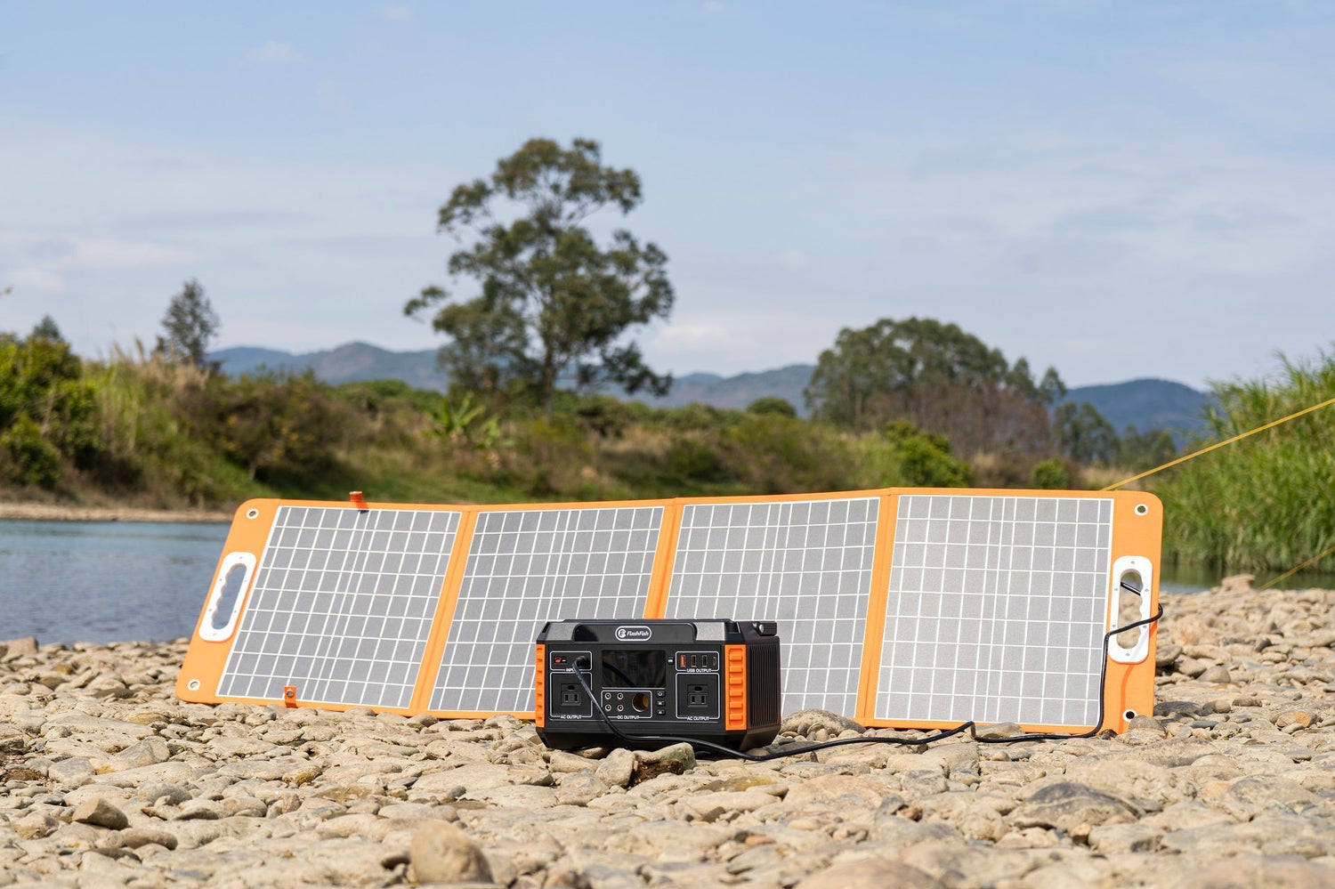 FlashFish foldable solar panel charging a portable power station outdoors