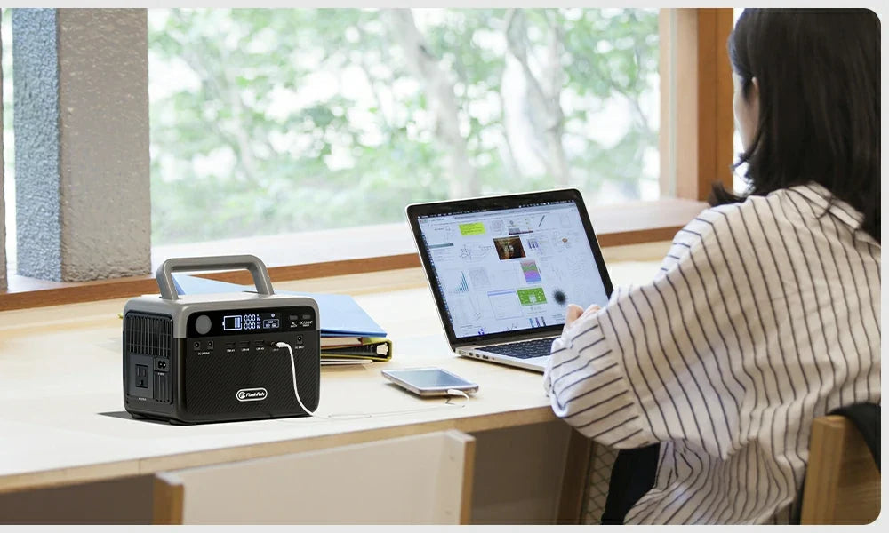 FlashFish portable power station beside a laptop on a home-office desk