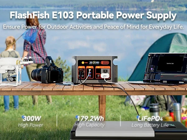 FlashFish E103 on an outdoor table connected beside a laptop and camera equipment