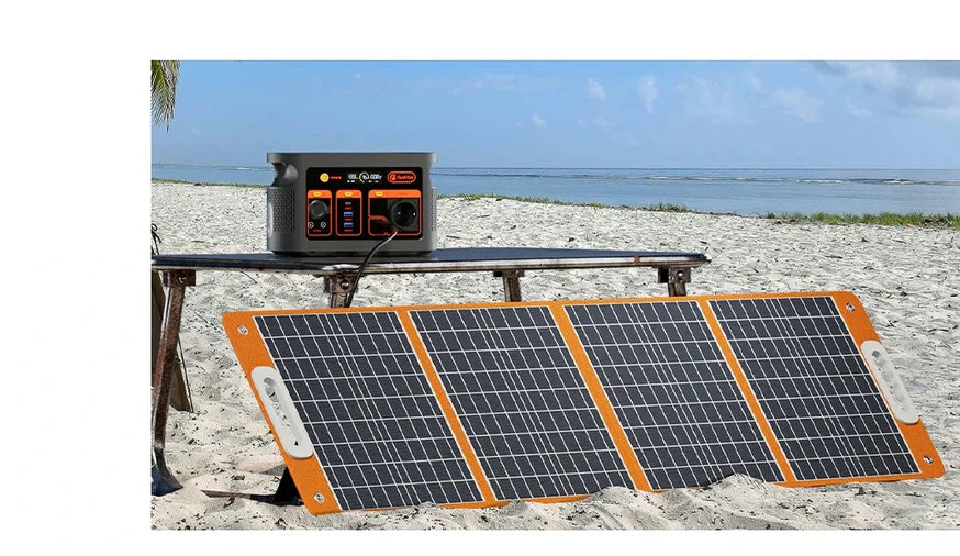 Foldable solar panel in front of a portable power station on a beachside bench.