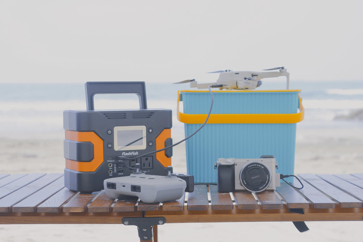 Portable power station with a drone and camera on an outdoor table