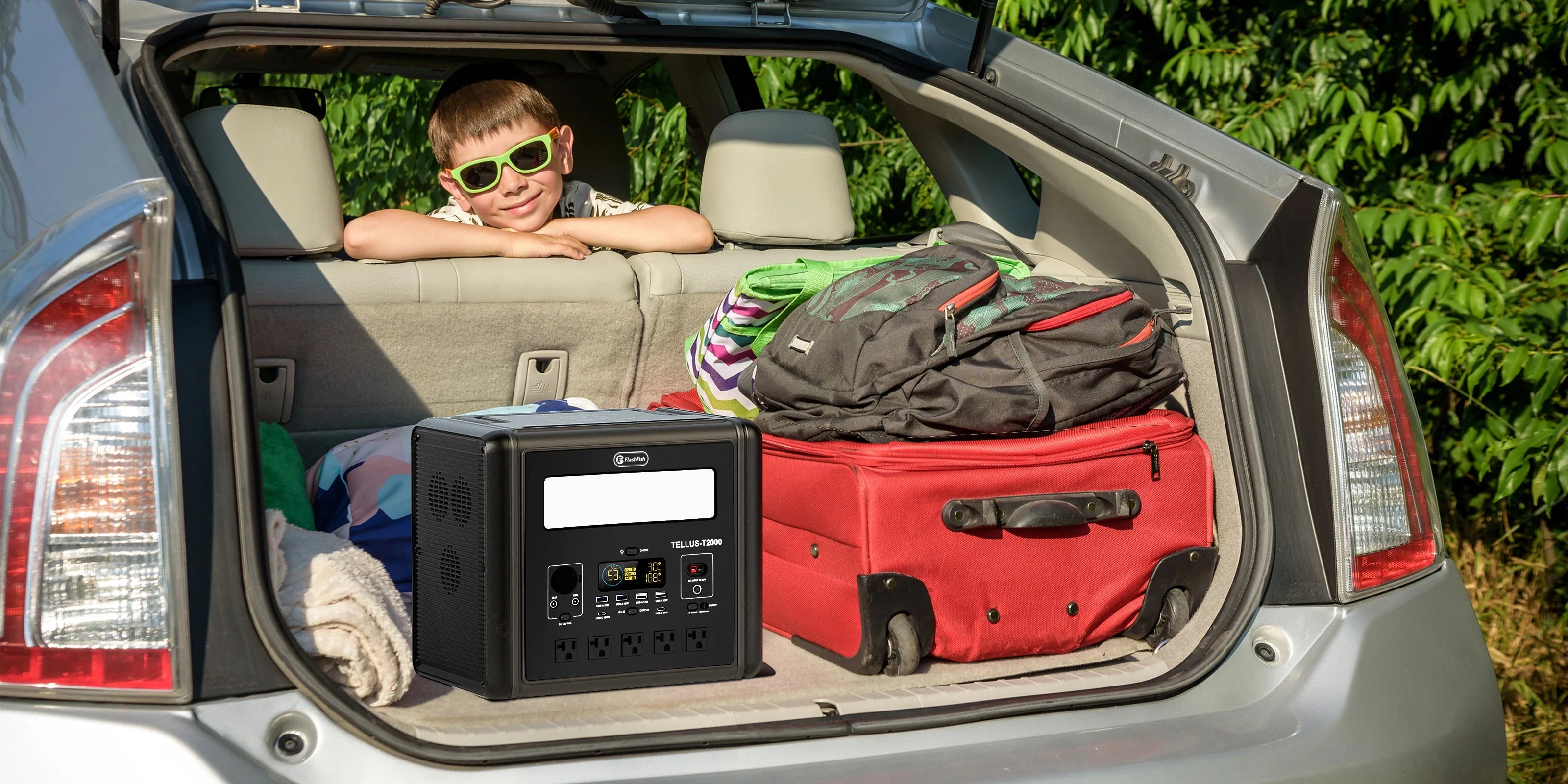 Portable power station and luggage packed in the open trunk of a car