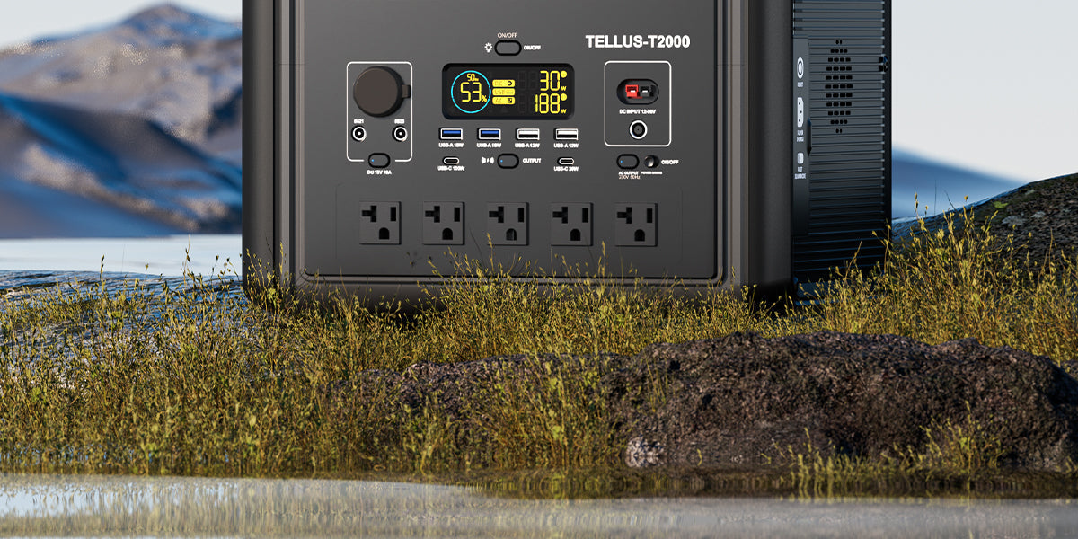 Large black portable power station beside grass and water.