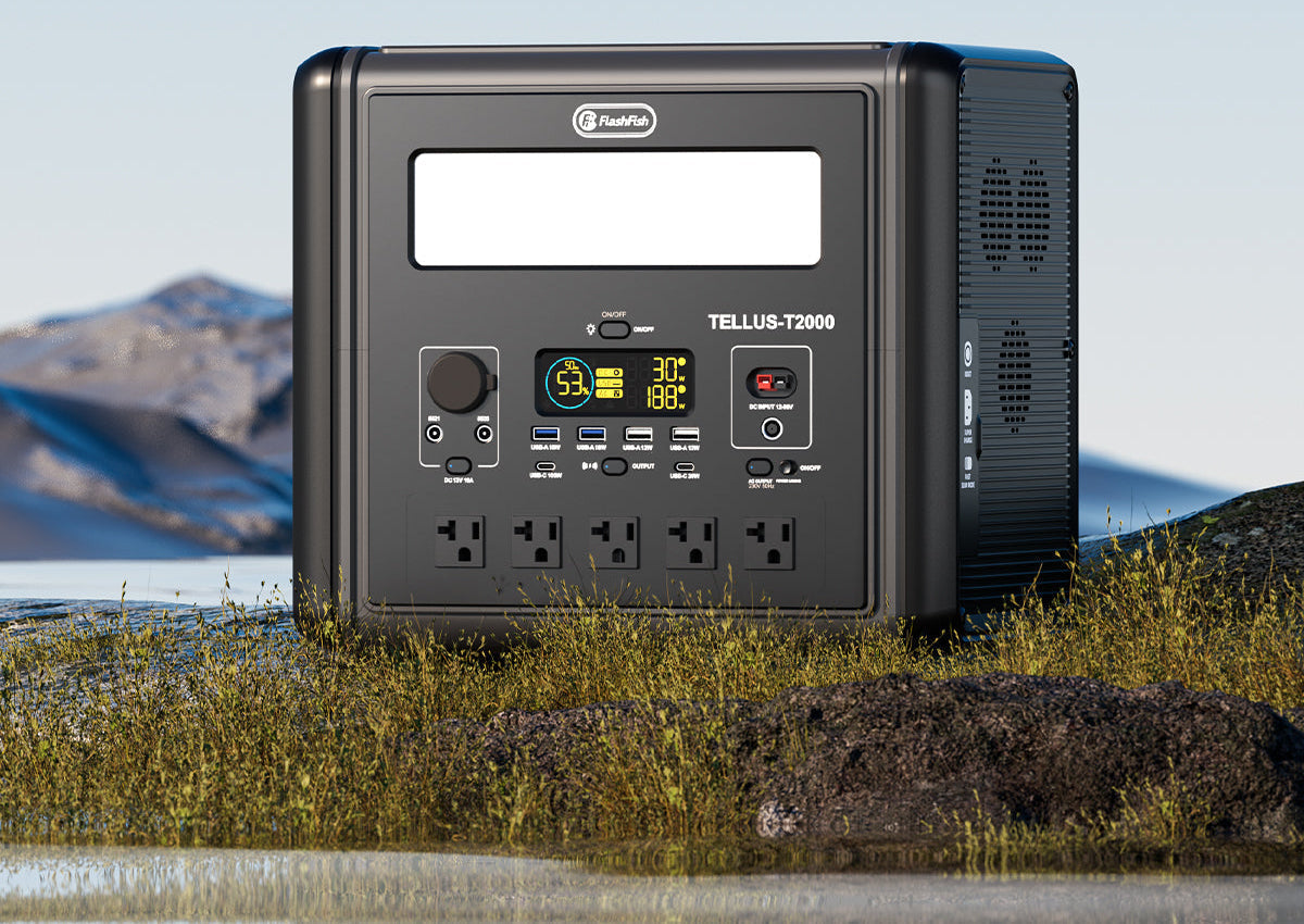 A TELLUS-T2000 portable power station on grass with a lake and mountains behind it.