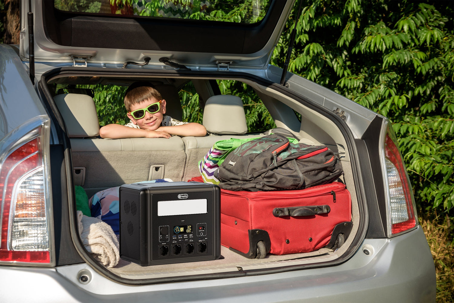 FlashFish portable power station packed in an open car trunk for a vehicle-adjacent event